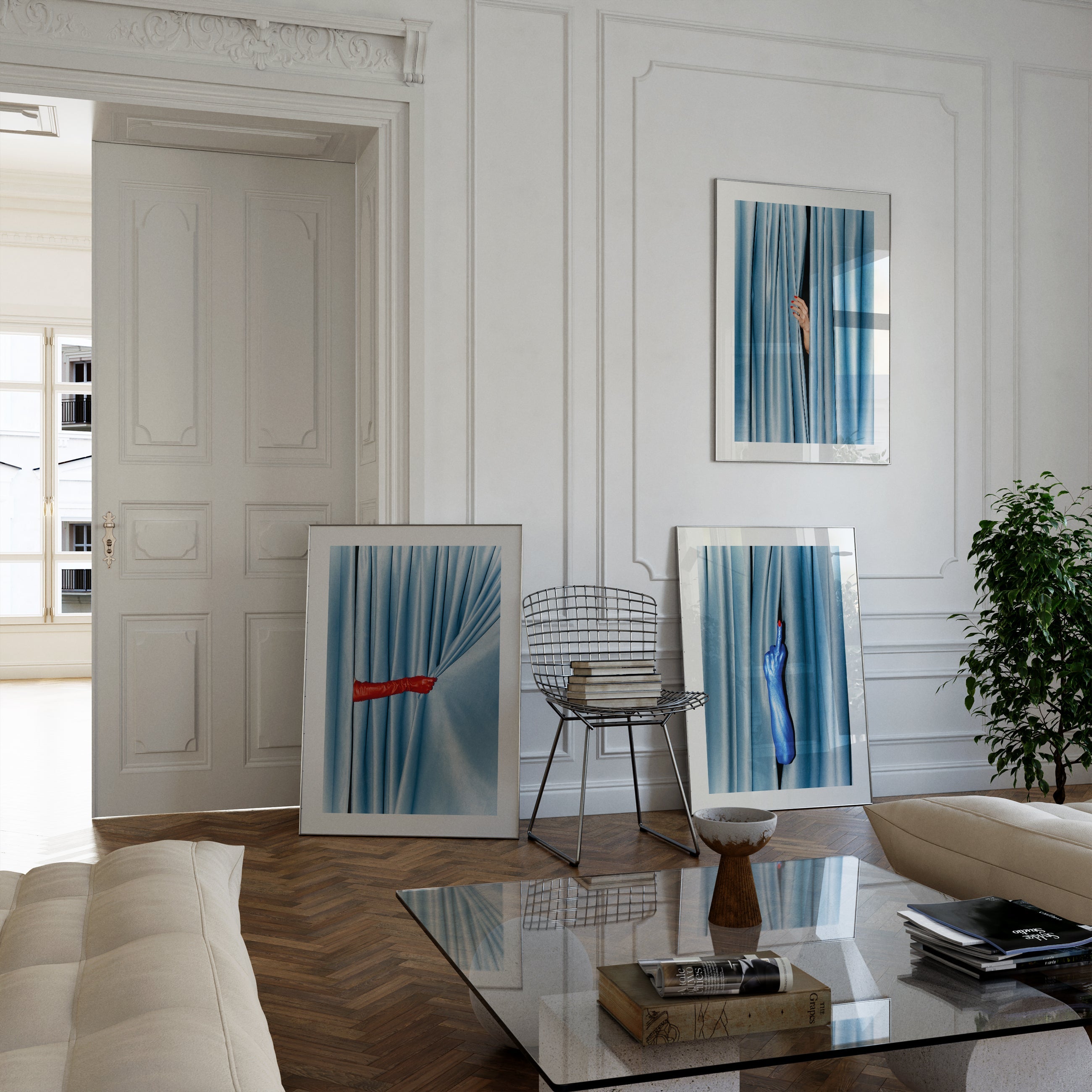 There is a black framed picture on the wall above  the  simple and  modern designed  sideboard.There is a modern table lamp on the side board. The picture on the wall you can see a A red-manicured woman's hand is visible, between  a blue velvet curtain