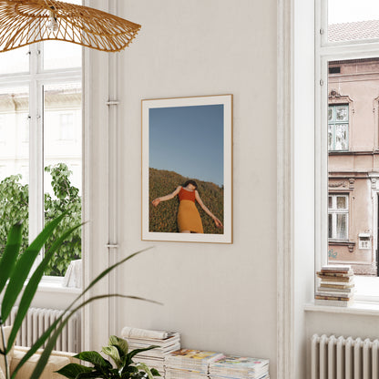 Wooden framed of a poster of model enjoying a hot summer day, hanged on a wall.